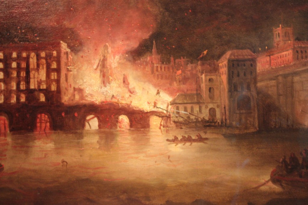 A historical painting depicting a city on fire, with flames and smoke rising from the buildings, while people in boats attempt to escape the scene.